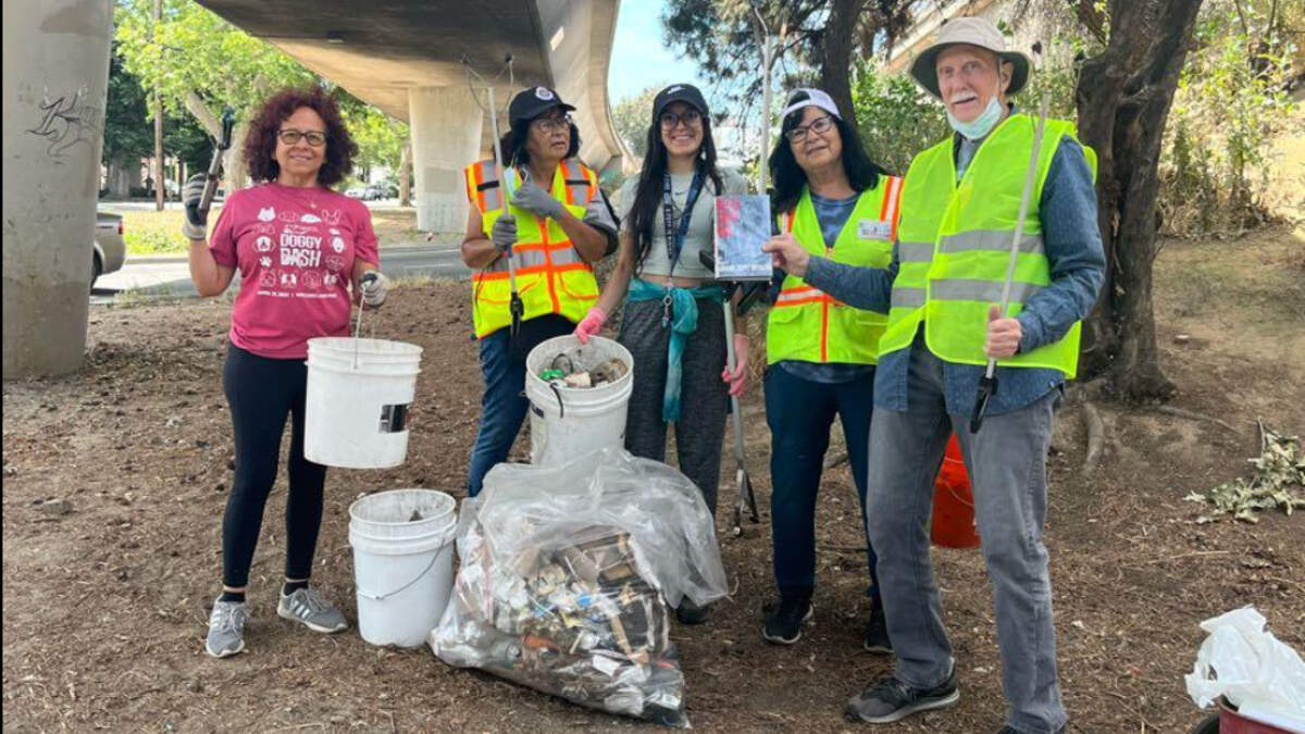 Volunteers work to clean up used syringes and other trash in Sacramento.